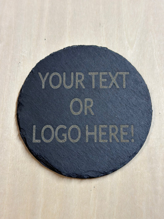 A round slate coaster with Your Text Or Logo Here! Placeholder text. 